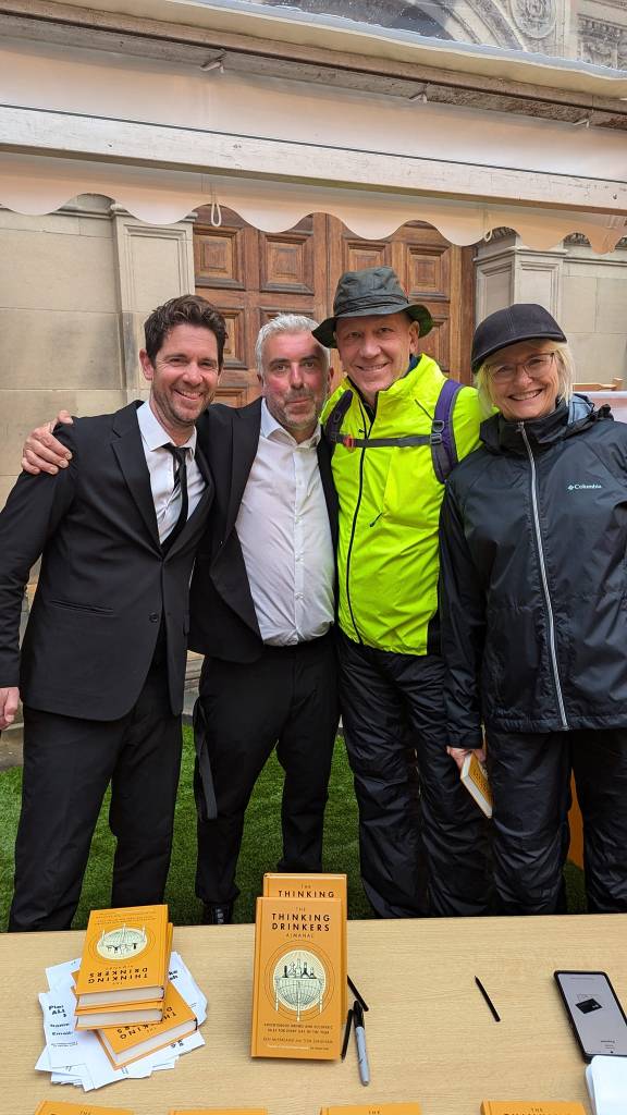 4 people standing and smiling