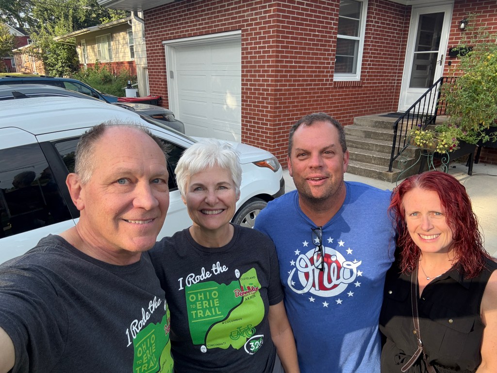 Friends posing in front of house